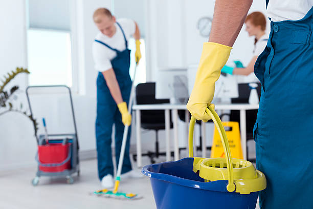 Image of person holding mop pail and man cleaning floor